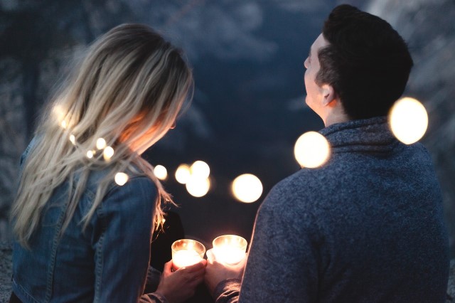 Couple holding candles on a date