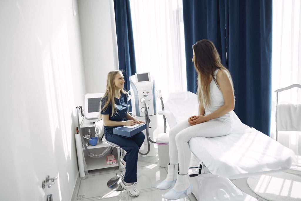 Nurse talking to a patient on a hospital bed