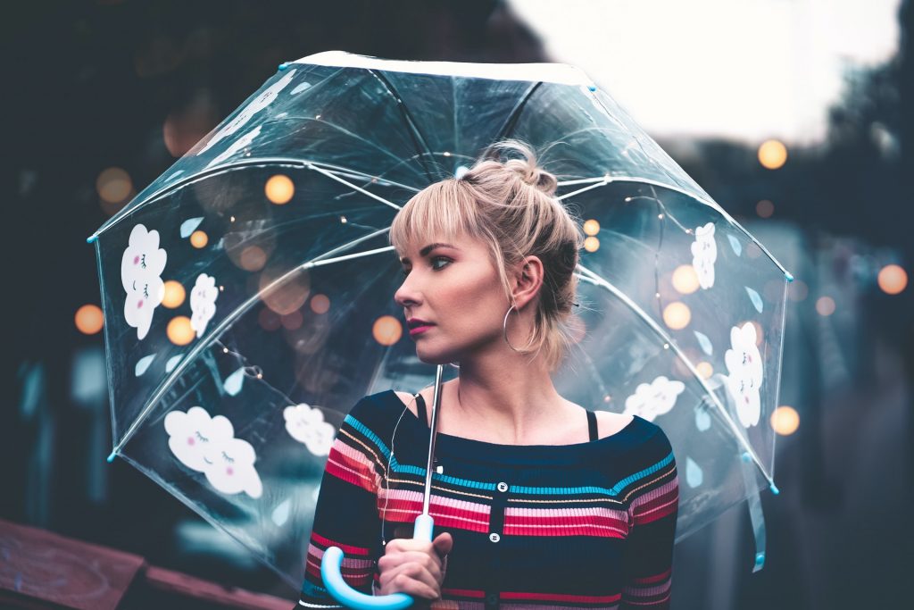 Pretty Girl with an umbrella in a striped shirt