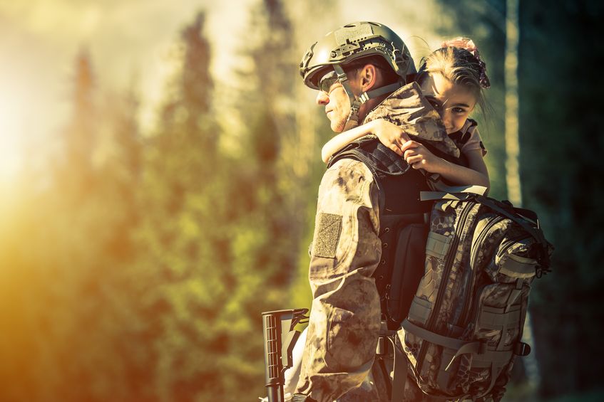 Military man with his child in the woods