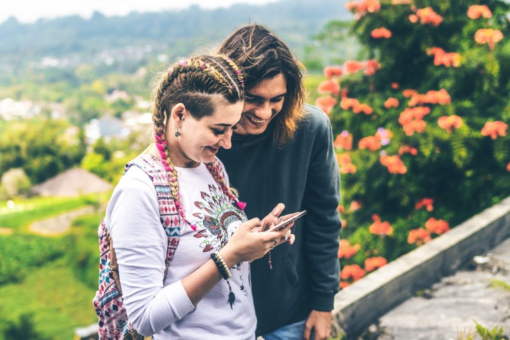 Couple looking at a phone near flowers