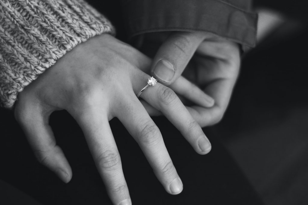 Black and white picture of couples hands who are engaged