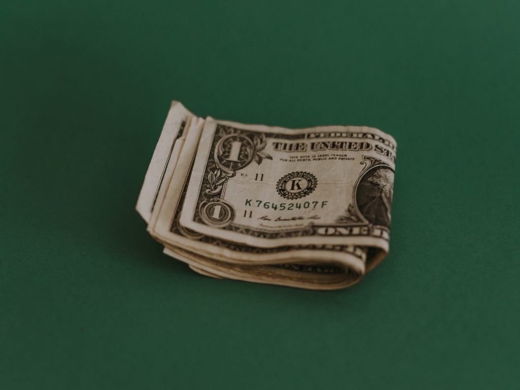 Money in a stack with a green background