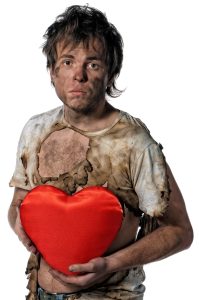 A Dirty White Man Holding a Heart-Shaped Box of Chocolates